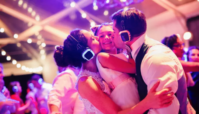 Bride and Groom Kissing Flower Girl with Silent DJ Headphones On
