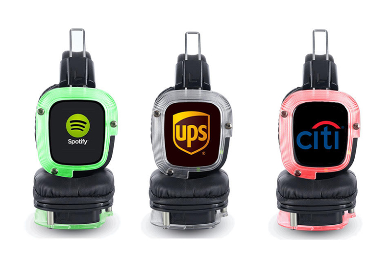 Custom branded silent disco headphones with sponsor and company logos.