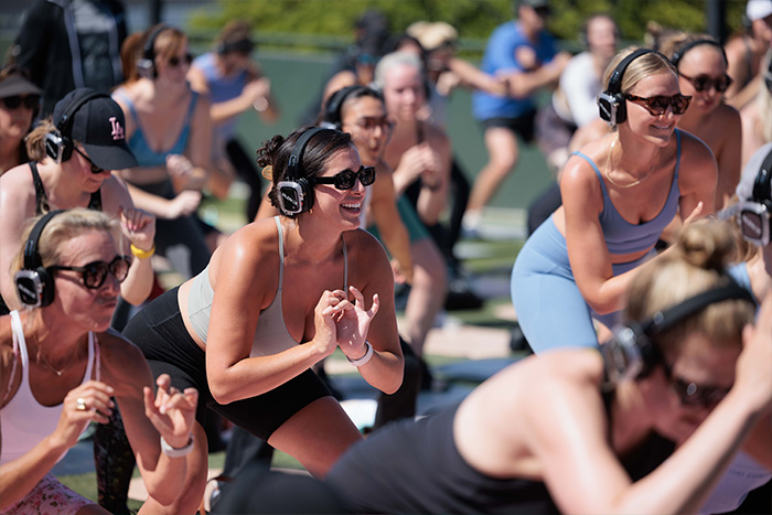 Fitness class wearing silent yoga headphones