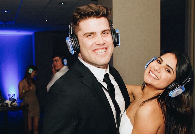 Silent wedding attendees wearing silent headphones while focused on a presenter
