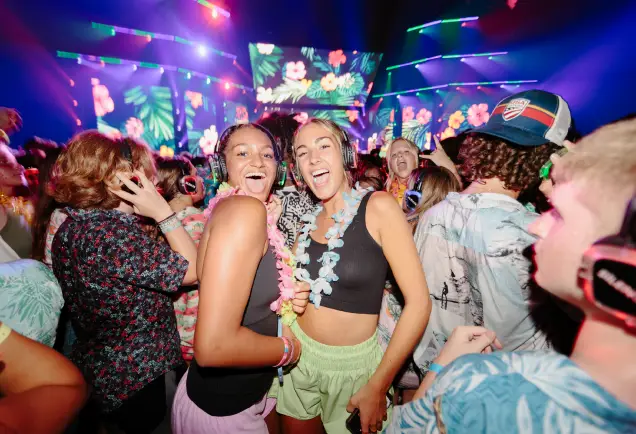 Silent festival attendees wearing silent headphones while focused on a presenter