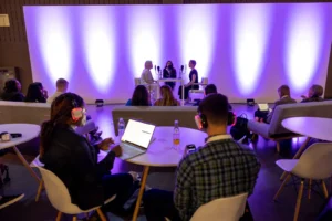 Showing how Audience listening to a live podcast through wireless silent headphones